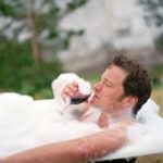 man in tub with wine