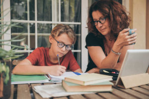 online homeschool program mom and son at desk