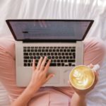 biohacking help woman on bed with  computer and coffee cup